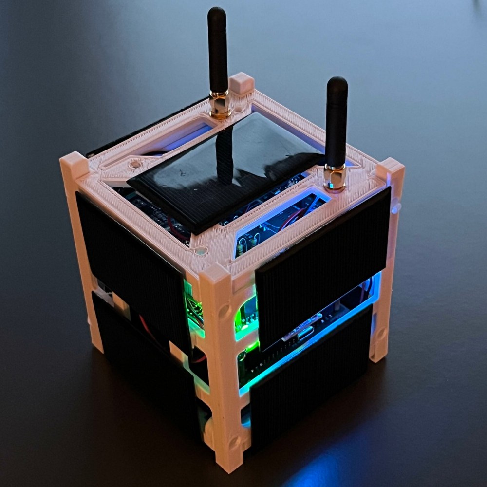 Figure 5 — The 3D-printed 1U frame with solar panels mounted on the faces and the board stack inside.